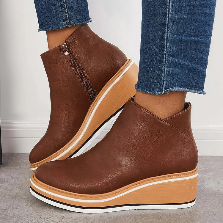Dark brown ankle boots with side zipper and tan platform wedge, white sole trim