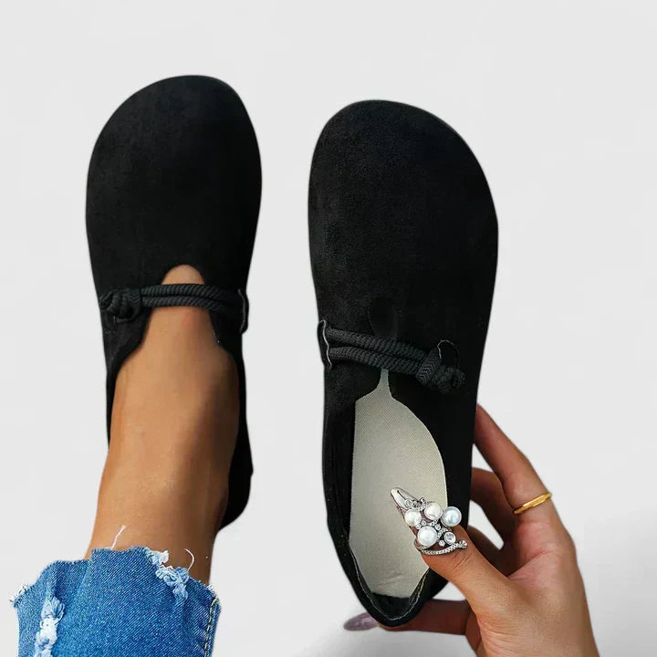 Black orthopedic loafer slip-on with bow strap detail at the front