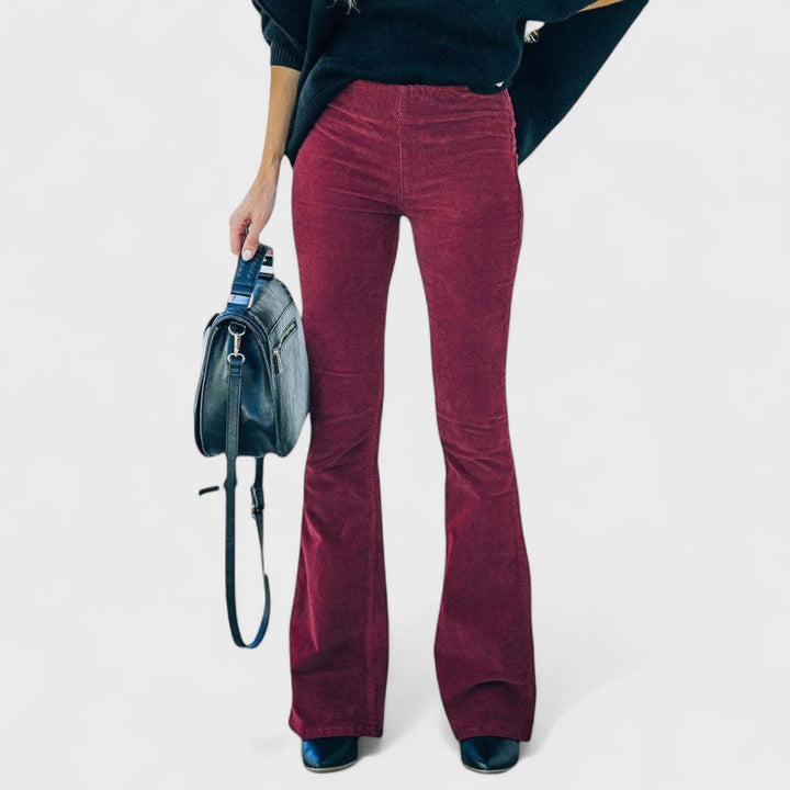 Flared corduroy trousers, burgundy red with vertical ridges and flared hem