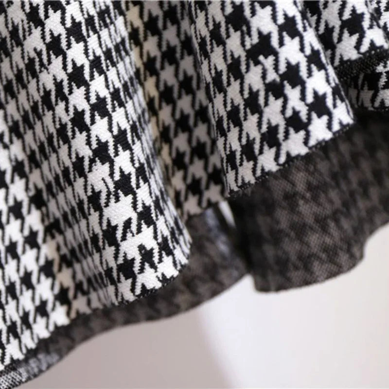 Houndstooth skirt hem with draped side slit and dark underlayer