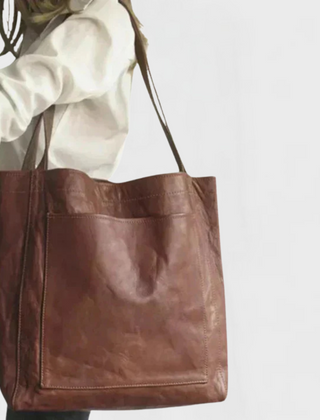 Brown leather tote bag with wide straps and square front panel