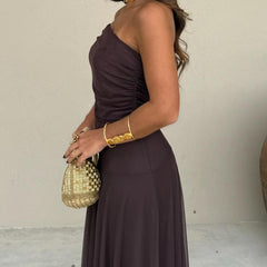 Dark plum sleeveless off-shoulder maxi dress with ruched bodice and flowing skirt