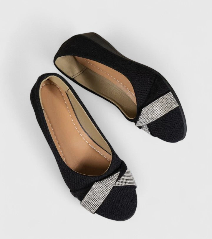Black orthopedic flats with silver glitter strap, showing tan interior