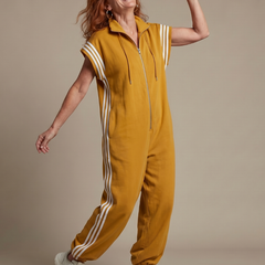 Mustard yellow zip-front jumpsuit with white striped sleeves and drawstring hood