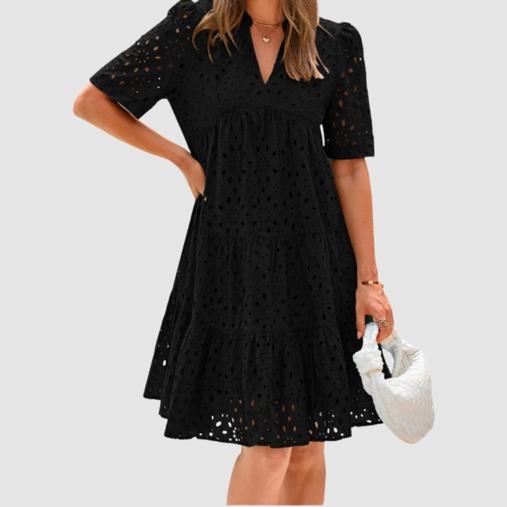 Black V-neck tiered babydoll summer dress, short sleeves, dotted pattern.