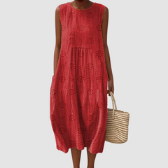 Red sleeveless midi dress with embroidered eyelet clover pattern, tiered skirt