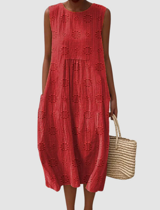 Red sleeveless midi dress with embroidered eyelet clover pattern, tiered skirt
