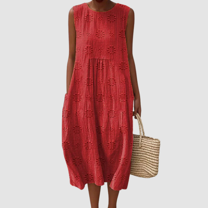 Red sleeveless midi dress with embroidered eyelet clover pattern, tiered skirt
