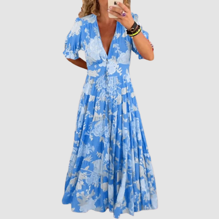 Blue long floral dress with V-neck, short puff sleeves, tiered skirt