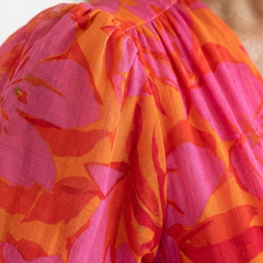 Pink floral puff sleeve detail with gathered neckline and billowy ruffles