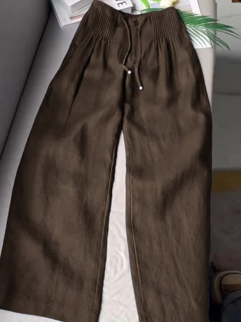 Dark brown wide-leg trousers with elastic waistband, drawstring, and front button