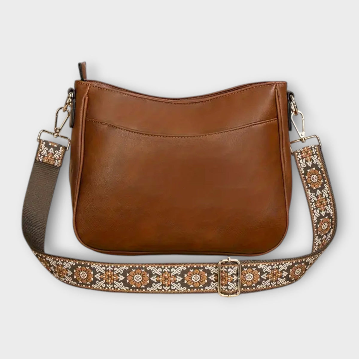 Brown crossbody bag with patterned webbing strap, chain links, and top zip