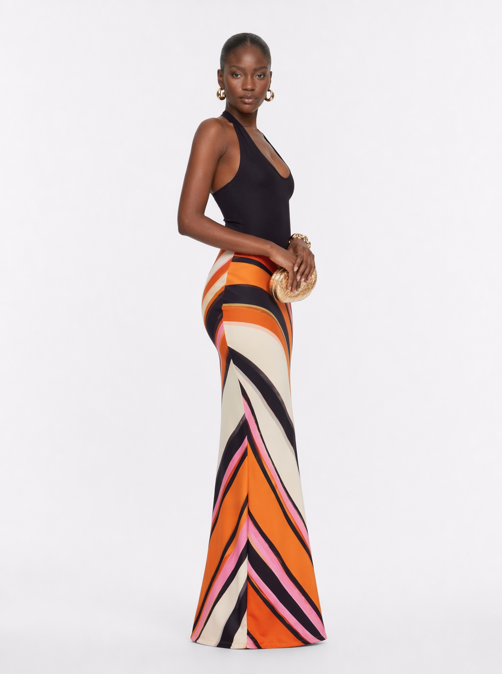 Halter maxi dress with black bodice and orange, cream, pink geometric stripe skirt