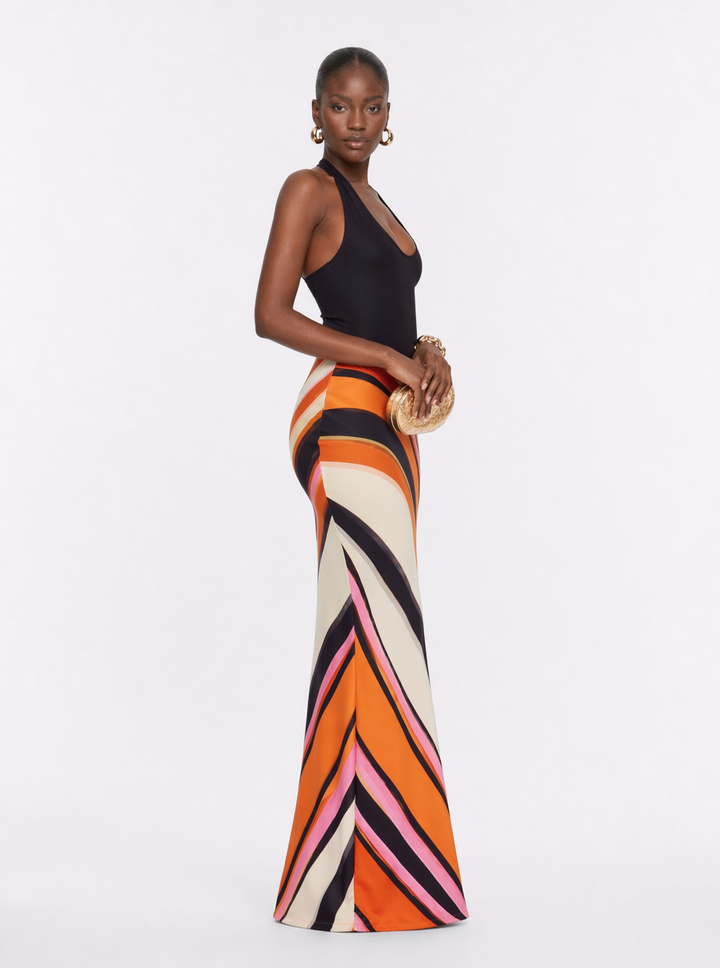 Halter maxi dress with black bodice and orange, cream, pink geometric stripe skirt