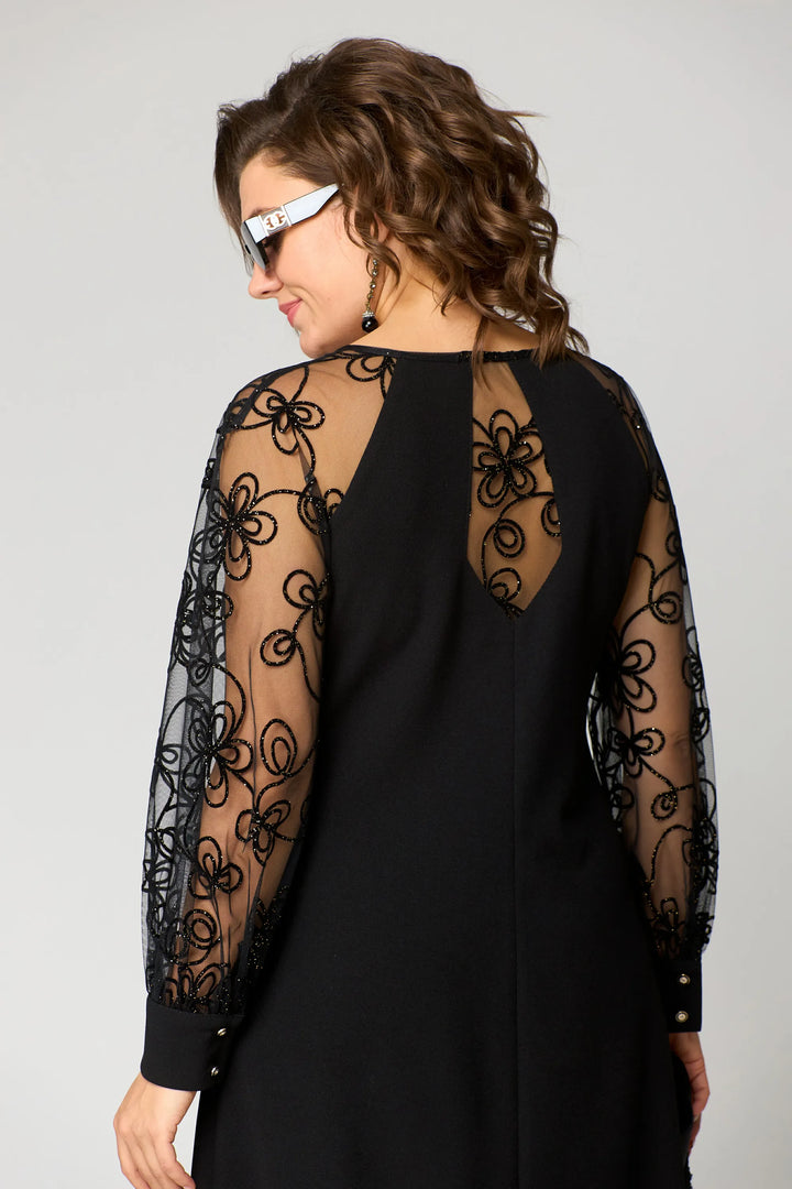 Black dress back view with sheer lace long sleeves and lace-covered shoulders.