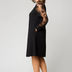 Black knee-length dress with sheer lace sleeves and fitted bodice, midi hem.