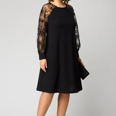 Black midi dress with lace long sleeves and round neckline, standing pose