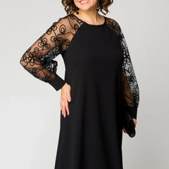 Black midi dress with sheer lace sleeves and round neckline; fitted waist.