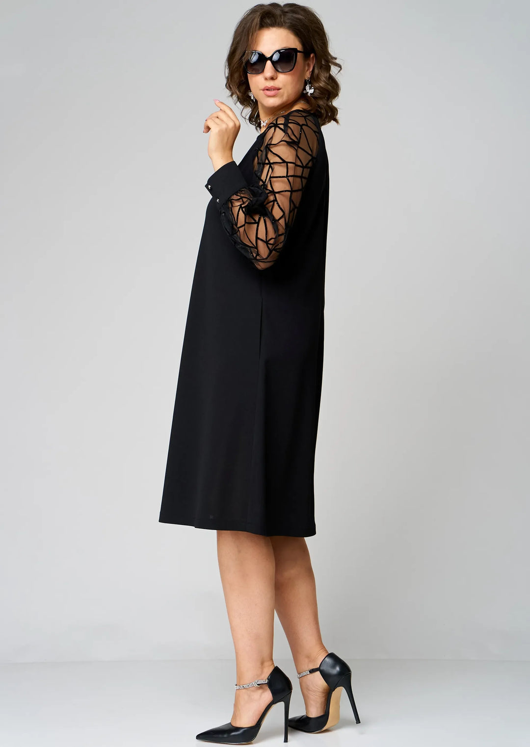 Black tunic dress with sheer lattice sleeves and simple crew neckline