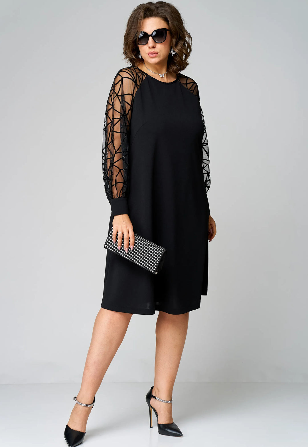 Black tunic dress front view with sheer mesh sleeves and knee-length hem