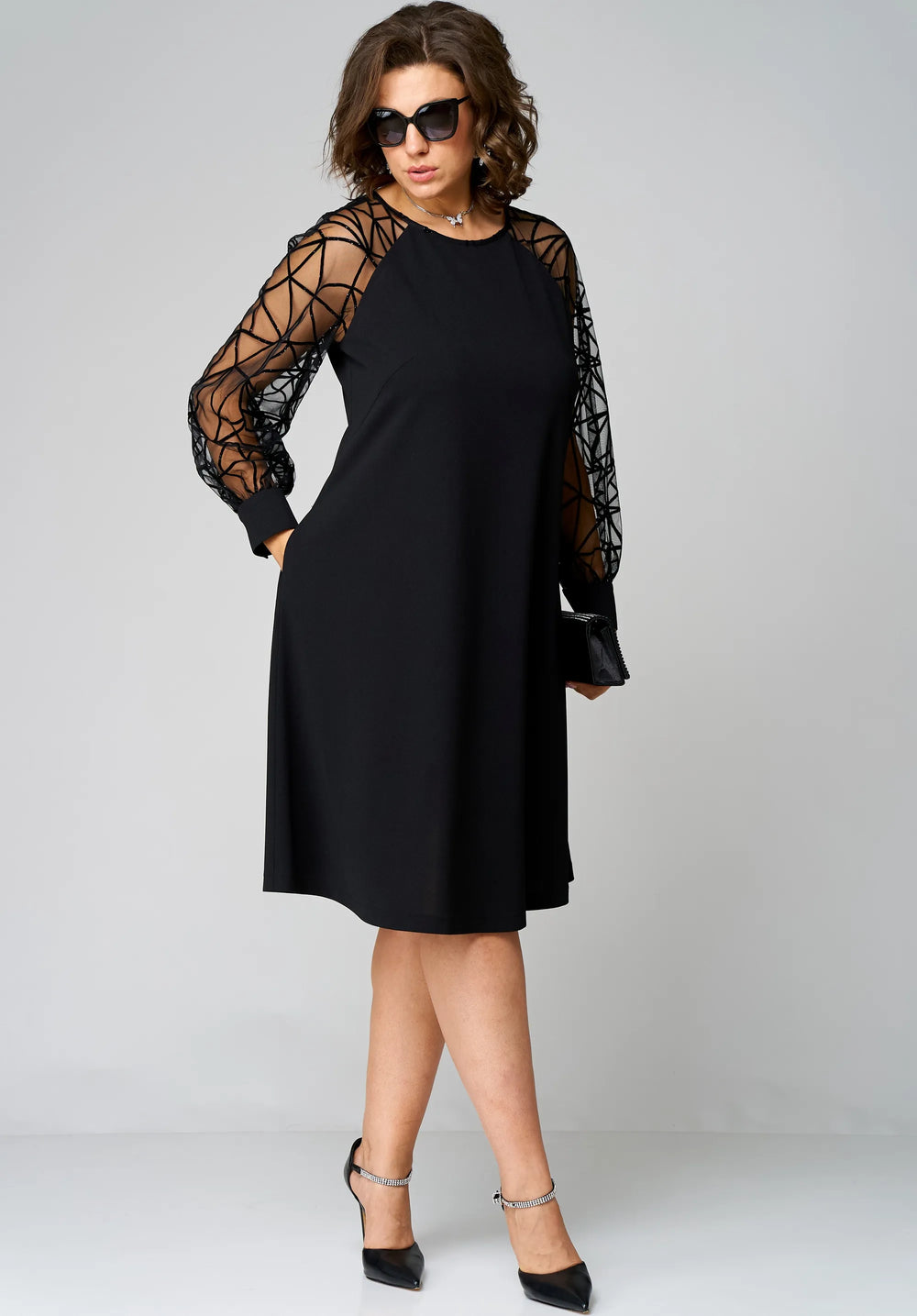 Black tunic dress with long sheer mesh sleeves and loose knee-length hem