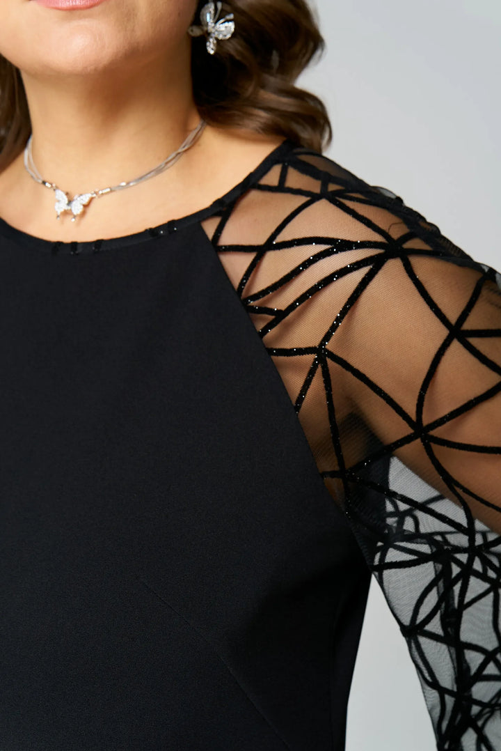 Black tunic dress close-up with crew neckline and sheer mesh shoulder overlay