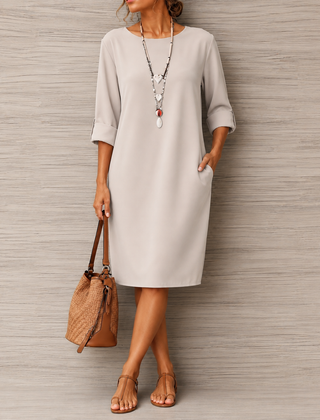 Off-white midi dress with round neckline, 3/4 sleeves, and relaxed straight fit