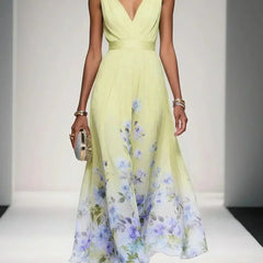 Light green sleeveless V-neck floral dress with gathered waist and flowing midi skirt