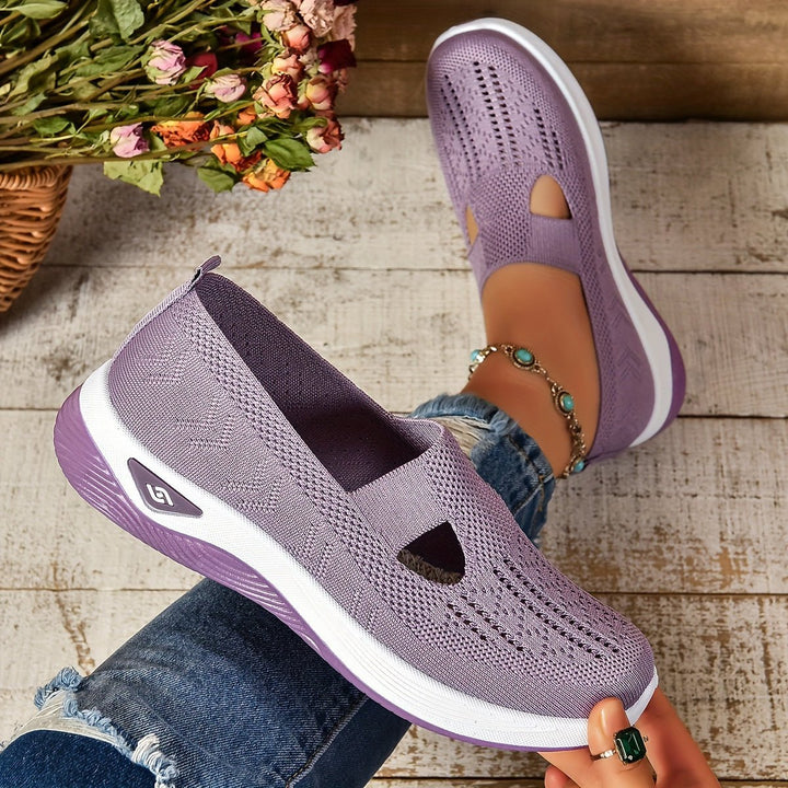 Lilac orthopedic slip-on shoes showing heel and perforated upper with white platform sole