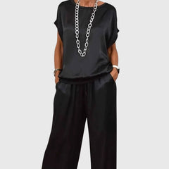 Black satin two-piece set with short-sleeve top and drawstring wide-leg pants
