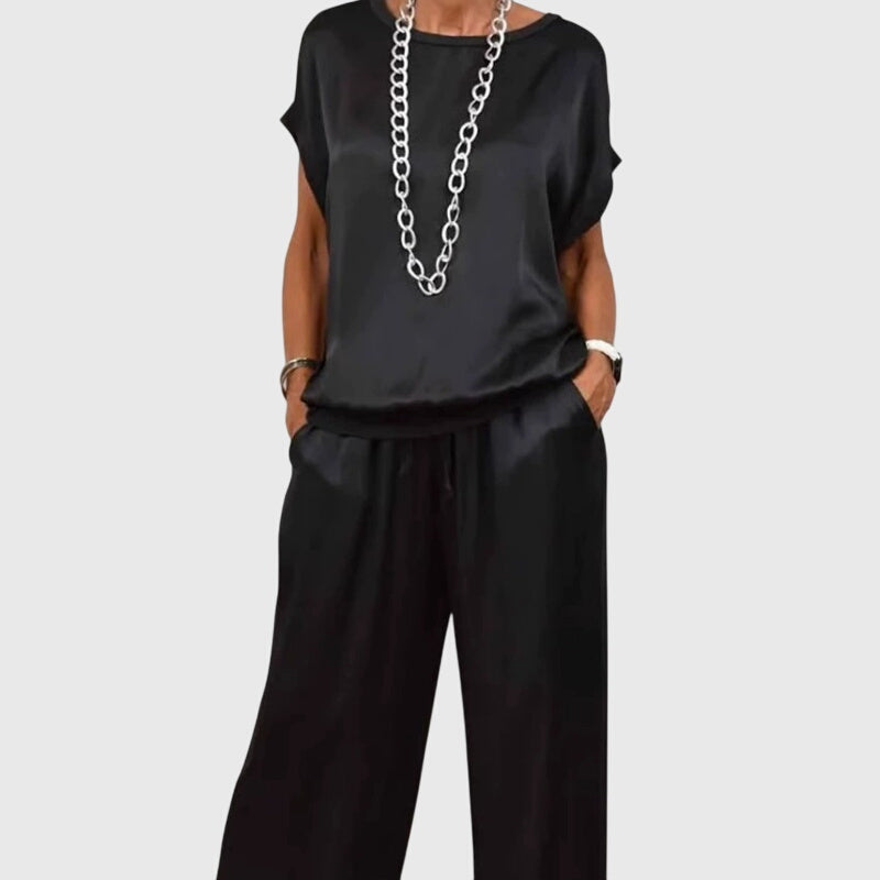 Black satin two-piece set with short-sleeve top and drawstring wide-leg pants