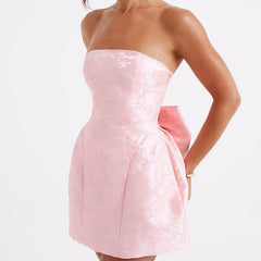 Pink strapless jacquard mini dress with side profile and large waist bow-knot