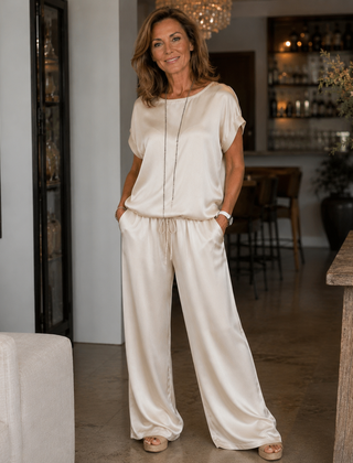 White satin two-piece set with short-sleeve top and drawstring wide-leg pants
