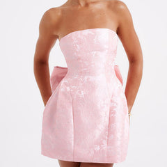 Pink strapless jacquard mini dress with structured bodice and waist bow knot