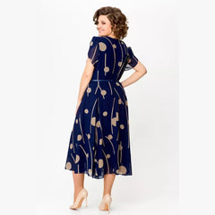 Navy polka dot chiffon midi dress with waist tie belt and short sleeves, side view