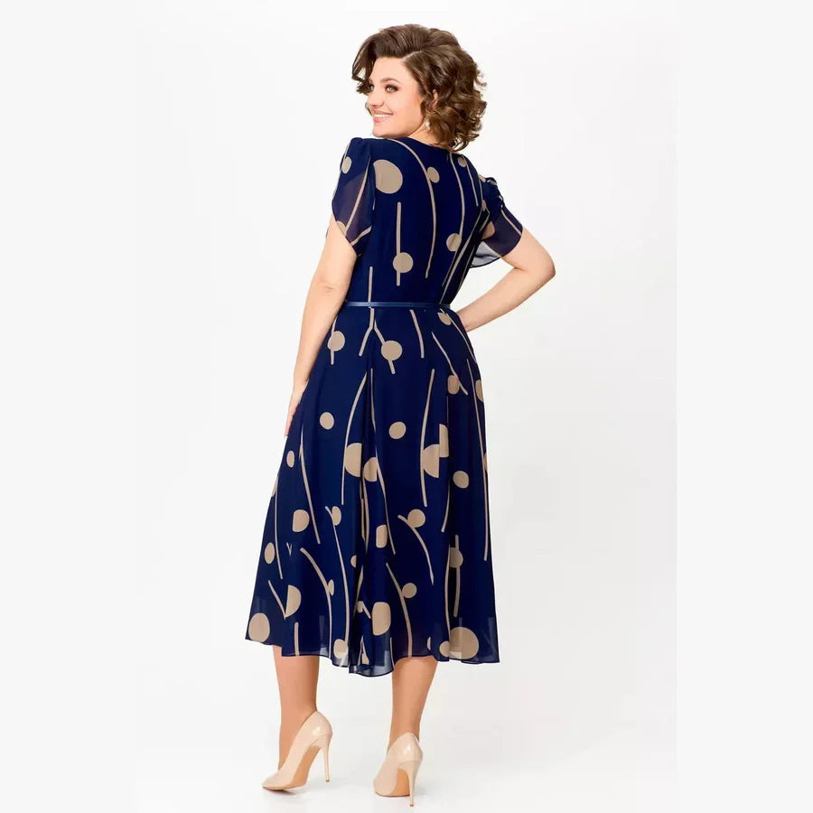 Navy polka dot chiffon midi dress with waist tie belt and short sleeves, side view