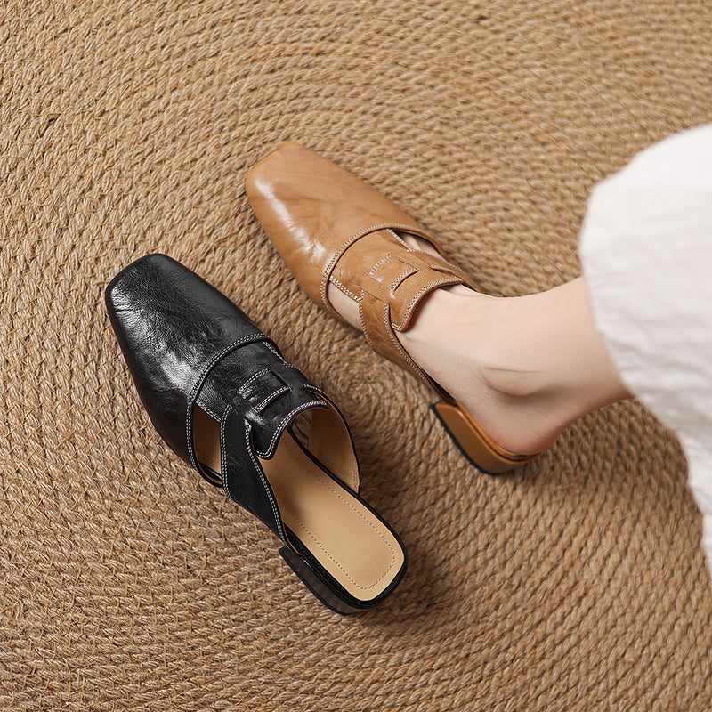 Black and apricot leather mules side by side; pointed toe and crossover straps