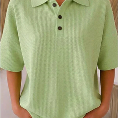 Light green waffle knit polo blouse with short sleeves, pointed collar, three-button placket