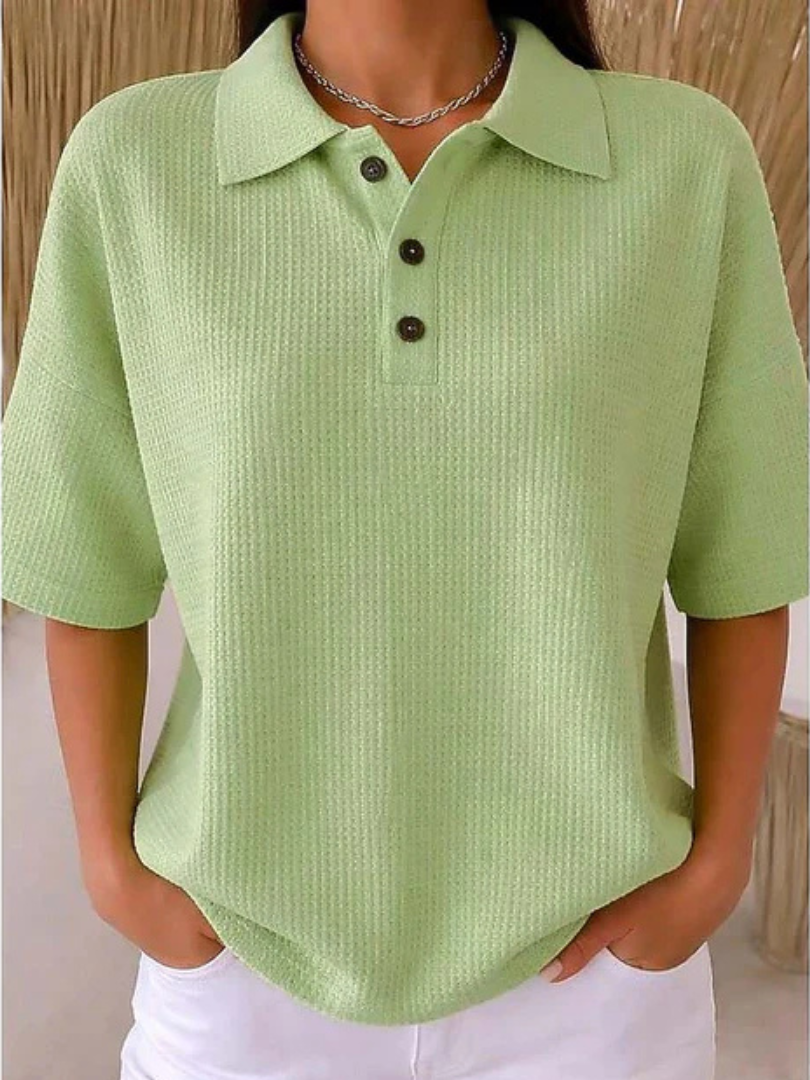 Light green waffle knit polo blouse with short sleeves, pointed collar, three-button placket