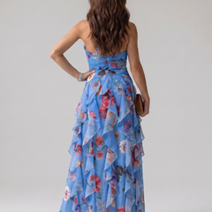 Blue halter-neck floral maxi dress back view with ruched waist and tiered ruffles