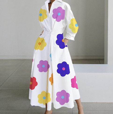 White shirt dress with colorful flower prints, long sleeves, collar, belted waist