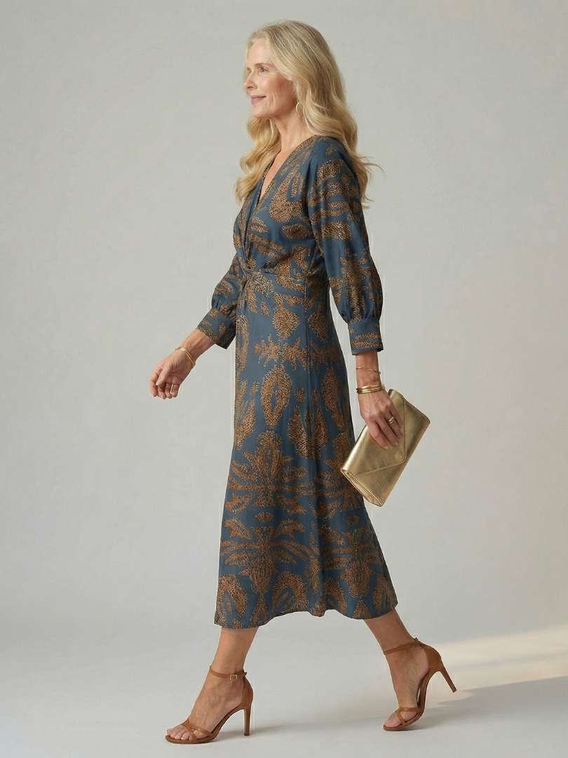 Blue wrap midi dress with long sleeves and gold leaf pattern, V-neck and waist tie