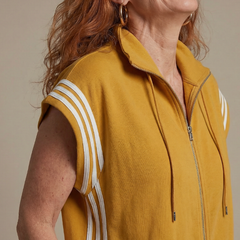 Mustard yellow zip-front jumpsuit with white stripe trim and drawstring hood