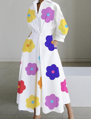 White shirt dress with colorful flower print, long sleeves, cinched waist