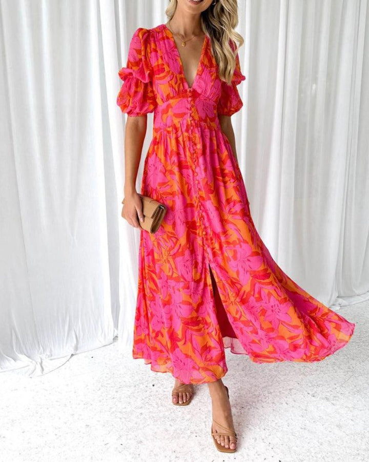 Long flowy dress with V-neck, ruffled short sleeves, pink and magenta floral print