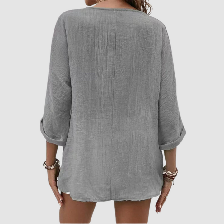 Gray breathable blouse back with center seam and three-quarter sleeves