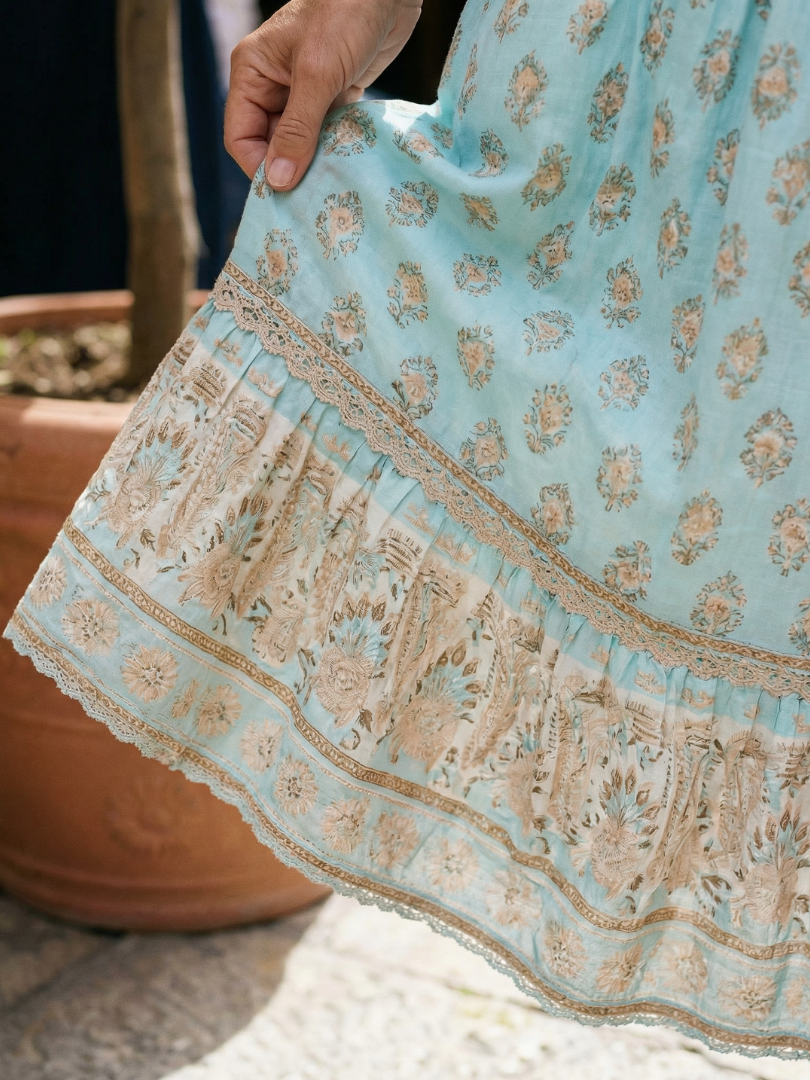 Light blue tiered dress hem detail with lace trim and floral border