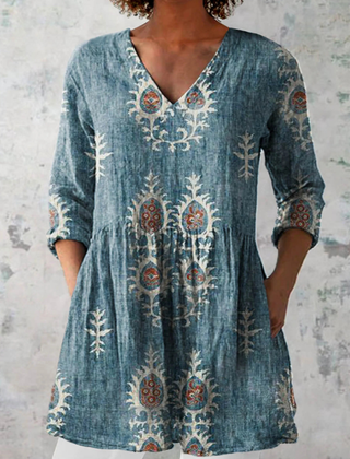 Blue long-sleeve V-neck embroidered blouse with gathered waist and ornate folk motifs