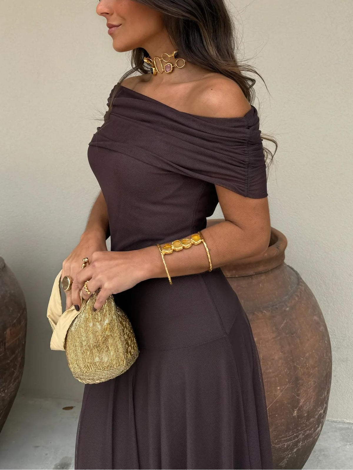 Dark plum off-shoulder draped maxi dress with ruched sleeves and full layered skirt