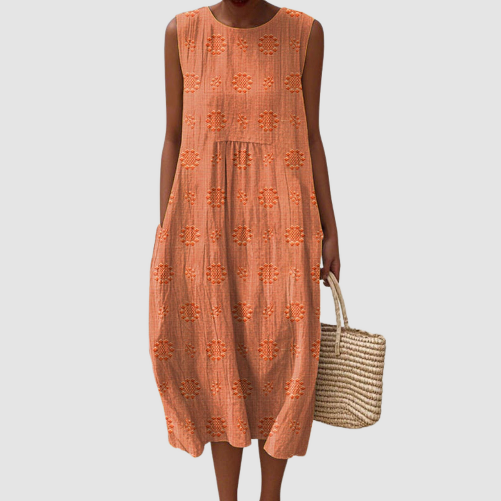 Orange sleeveless midi dress with embroidered eyelet clover pattern, tiered skirt